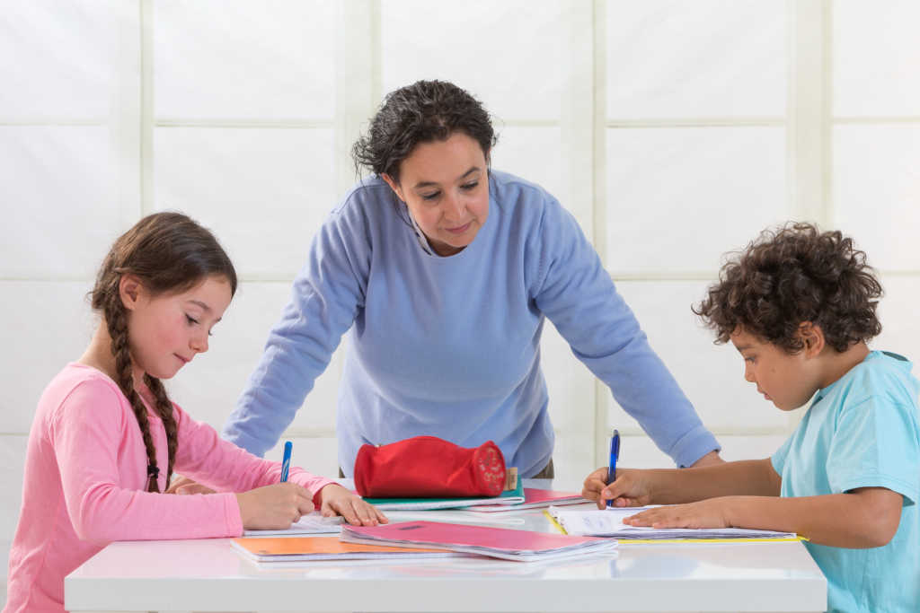 Children doing homework. (Photo by: BSIP/UIG via Getty Images)