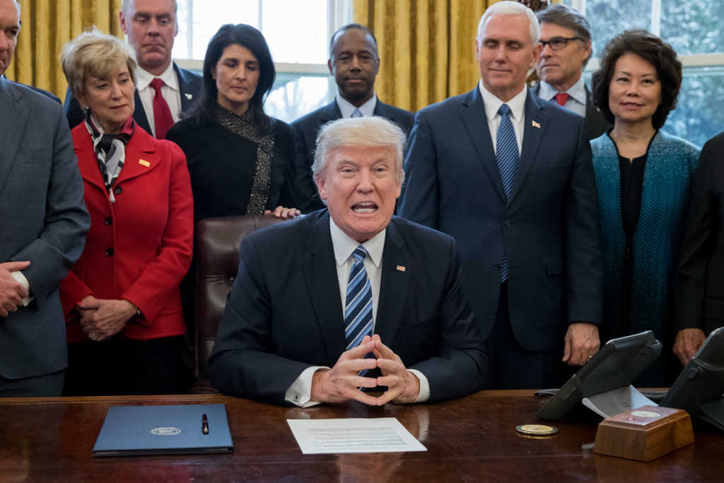 U.S. President Donald J. Trump delivers brief remarks before signing an executive order entitled, 'Comprehensive Plan for Reorganizing the Executive Branch', beside members of his Cabinet in the Oval Office of the White House on March 13, 2017 (Photo by Michael Reynolds-Pool/Getty Images)