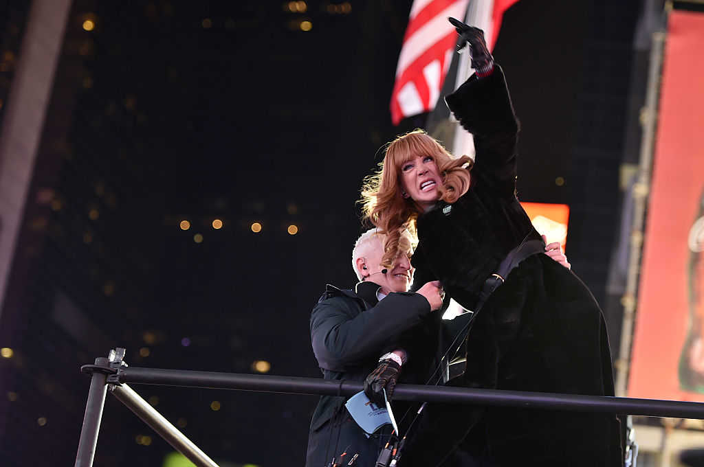 Kathy Griffin Yells at Ryan Seacrest from the media riser while Anderson Cooper restrains her (Theo Wargo/Getty Images)