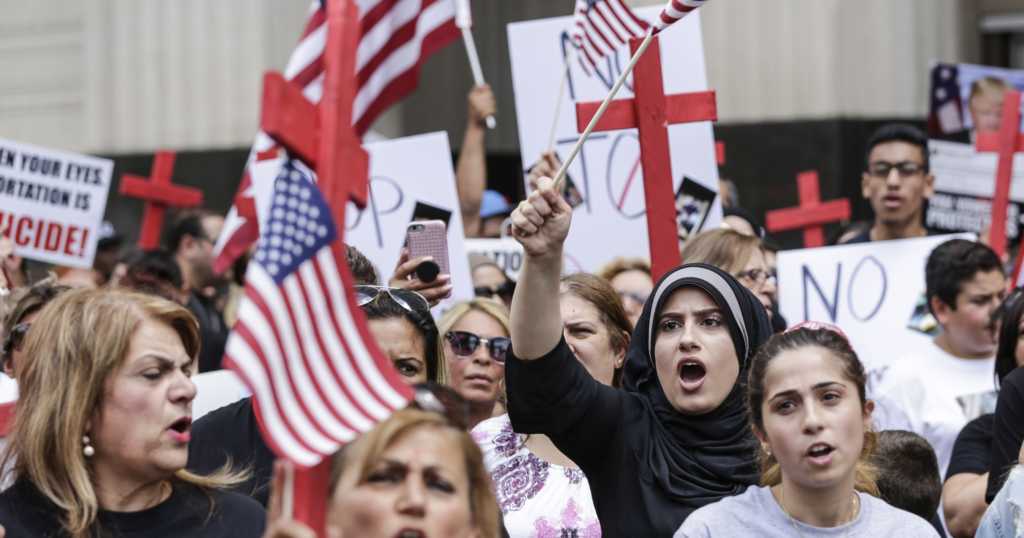 Demonstrators protest the arrest of Iraqi nationals by ICE agents outside of the Theodore Levin United States Courthouse, Wednesday, June 21, 2017 in Detroit, Michigan. (Photo credit: Junfu Han, Detroit Free Press)