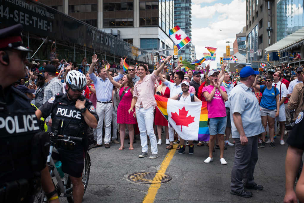 TORONTO, CANADA - JULY 3: Canadian Prime Minister Justin Trudeau (middle, waving flag) participates at the annual Pride Festival parade, July 3, 2016 in Toronto, Ontario, Canada. Prime Minister Justin Trudeau will make history as the first Canadian PM to march in the parade. (Photo by Ian Willms/Getty Images)