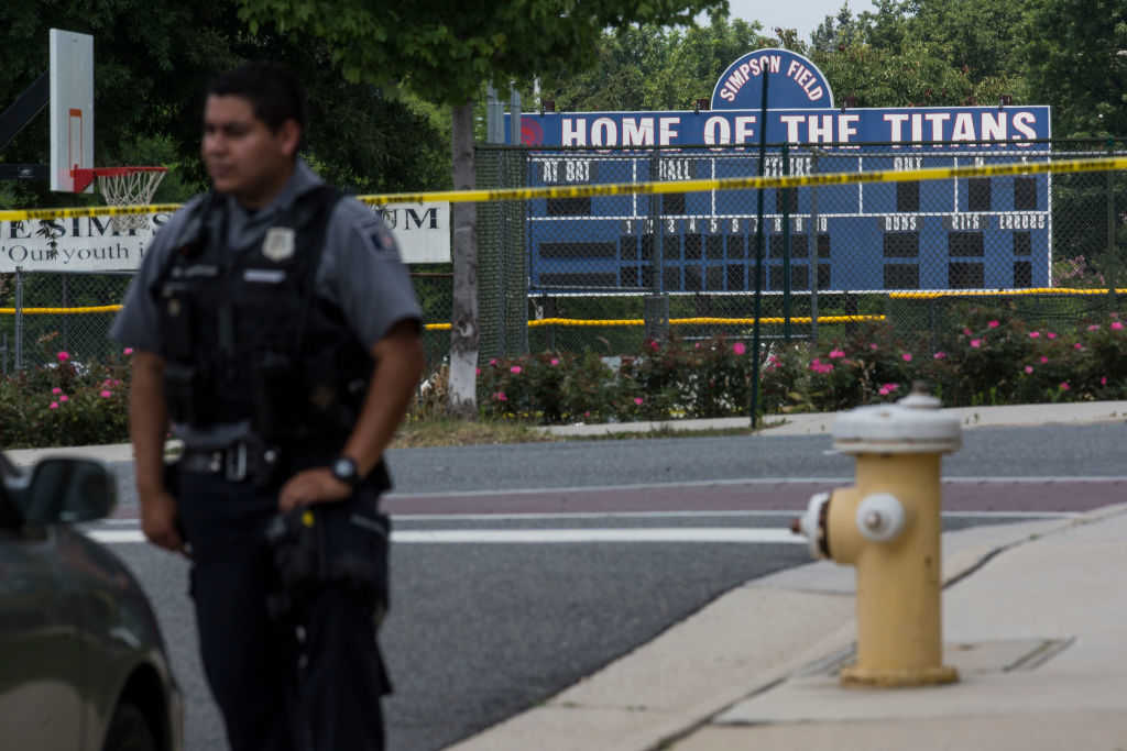 A police officer stands near Eugene Simpson Field, the site where a gunman opened fire June 14, 2017 in Alexandria, Virginia. Multiple injuries were reported from the instance, the site where a congressional baseball team was holding an early morning practice, including House Republican Whip Steve Scalise (R-LA) who was reportedly shot in the hip. (Zach Gibson/Getty Images)