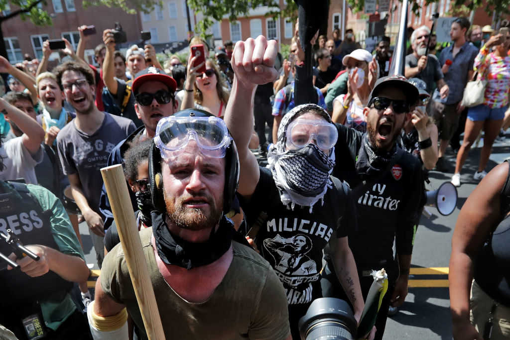 Anti-fascist counter-protesters wait outside Emancipation Park to hurl insluts as white nationalists, neo-Nazis and members of the "alt-right" are forced out after the "Unite the Right" rally was declared an unlawful gathering August 12, 2017 in Charlottesville, Virginia. After clashes with anti-fascist protesters and police the rally was declared an unlawful gathering and people were forced out of Emancipation Park, where a statue of Confederate General Robert E. Lee is slated to be removed. (Chip Somodevilla/Getty Images)