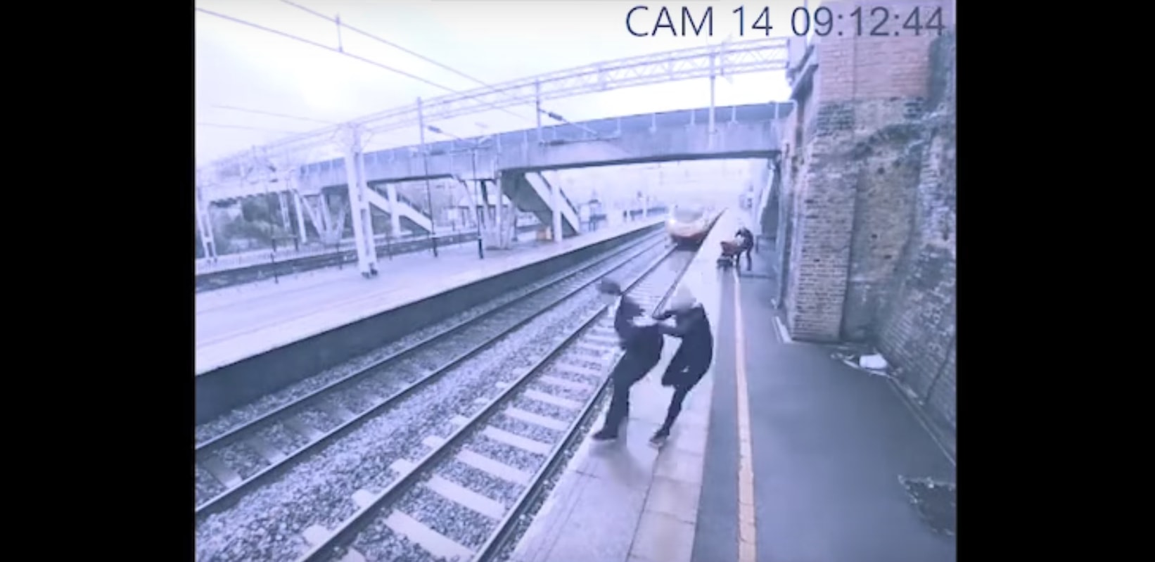 Staggering Footage Shows Woman Tackle a Suicidal Man Before He Jumps in