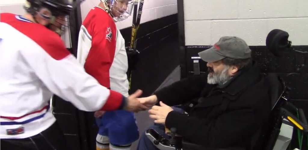 Father Dimitrie returns to the ice to greet players. Credit: Hometown Life.