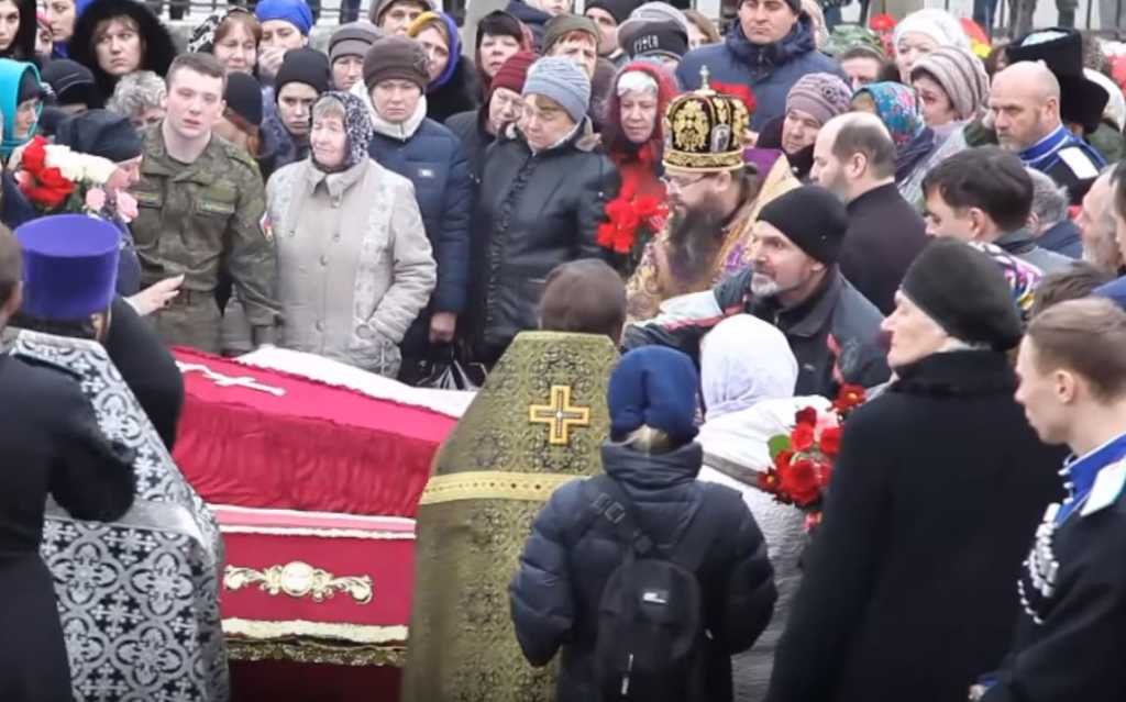 Friends and family mourn the dead after a shooting at a church in Russia's volatile Dagestan region. (Photo credit: (Photo credit: east2west news)