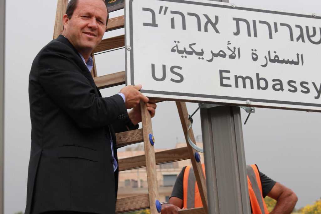 Jerusalem's Mayor, Nir Barkat, helps install a road sign for the new U.S. Embassy in Jerusalem, Israel. (Image source: Twitter/Nir Birkat)