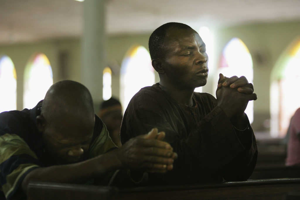 Nigerian Catholic worshippers pray during morning Mass April 12, 2005 in Kano, Nigeria. (Photo by Chris Hondros/Getty Images)
