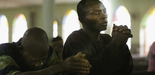 Nigerian Catholic worshippers pray during morning Mass April 12, 2005 in Kano, Nigeria. (Photo by Chris Hondros/Getty Images)