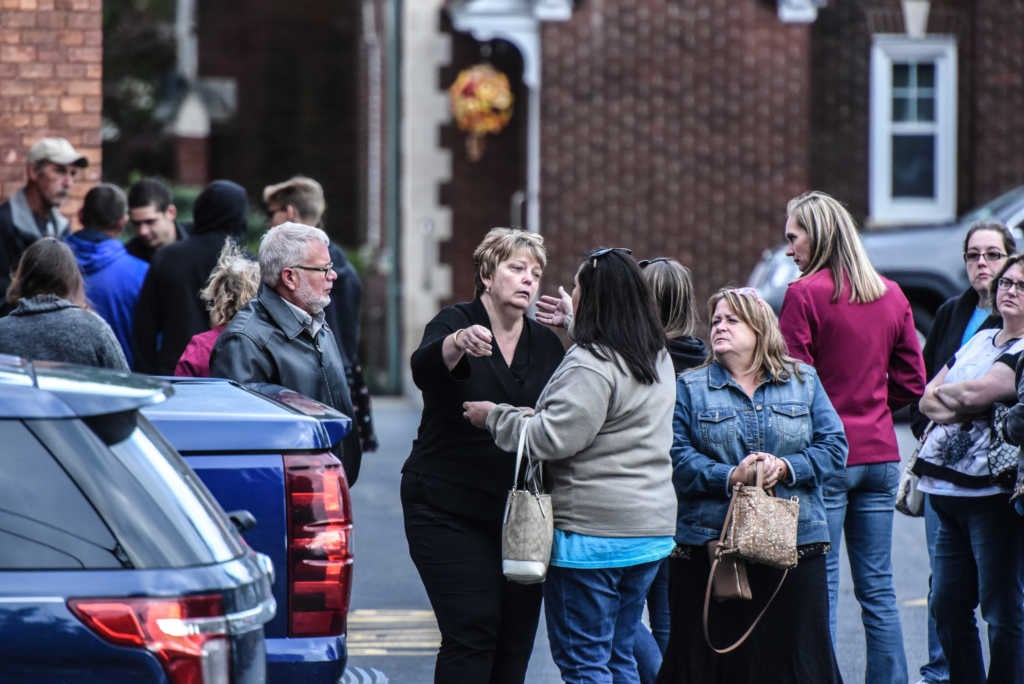 Mourners grieve after leaving a service at St. Stanislaus Roman Catholic Church for some of the victims in last weekend's fatal limo crash on October 12, 2018 in Amsterdam, New York. (Photo by Stephanie Keith/Getty Images)