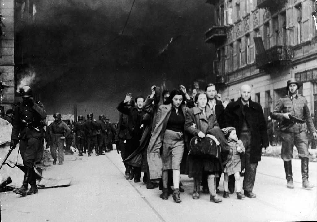 Captured Jewish civilians who participated in the Warsaw Ghetto Uprising are marched out of the city by Nazi troops, Warsaw, Poland, April 19, 1943. (Photo by Frederic Lewis/Getty Images)